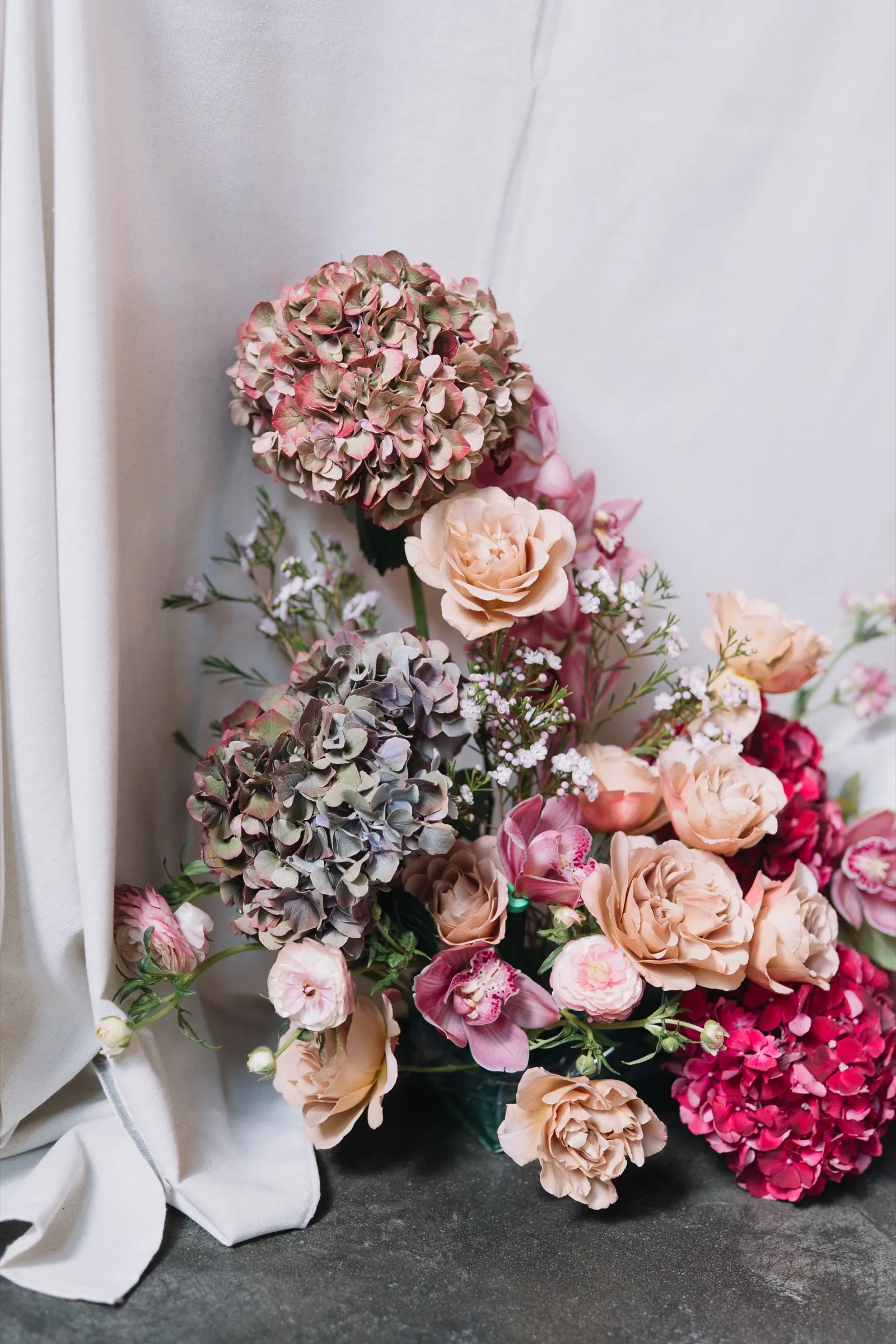Floral designer arranging a centerpiece during a consultation
